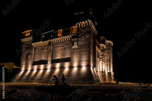 The medieval castle of Santa Severa medieval province of Rome, on the Tyrrhenian sea with the cliff of the promenade. During sunset with shadows of lights, Metropolitan City of Rome, Italy