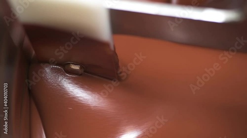 Liquid melted chocolate inside a chocolate conching machine. The machine grind the chocolate to smooth paste with friction and heat.