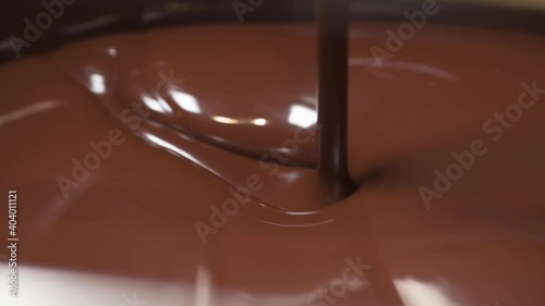Melted smooth chocolate liquid inside a chocolate tempering machine. The temperature is use to control the crystallisation.