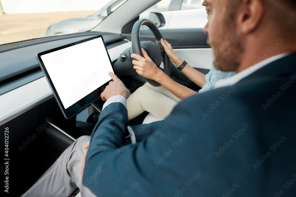 Selective focus on computer in car and man using it