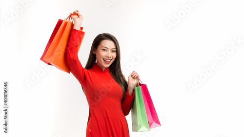 Obraz na plátně Smile beautiful happy woman holding shopping bags, sale on lunar new year celebr