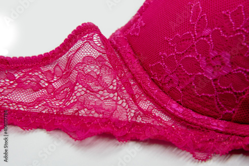 hot pink lace bra on white background
