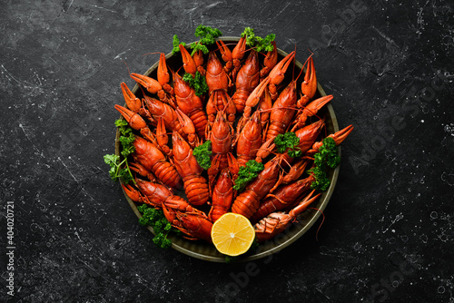 Boiled red crayfish with spices and herbs in a metal bowl. Top view. Flat lay.