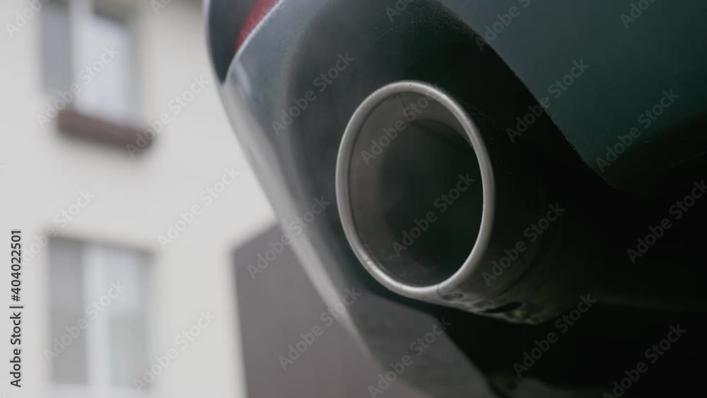 Smoke coming out of the car exhaust pipe, liquid formed by condensation. Smoke emissions fumes