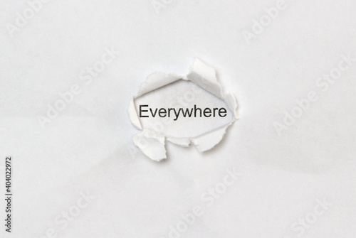 Word everywhere on white isolated background, the inscription through the wound hole in paper. Concept of gender identity and sexual minorities. Stock photo for web and print with empty space for text photo