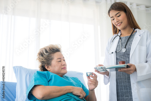 young woman doctor examining female patient person in hospital, health care concept