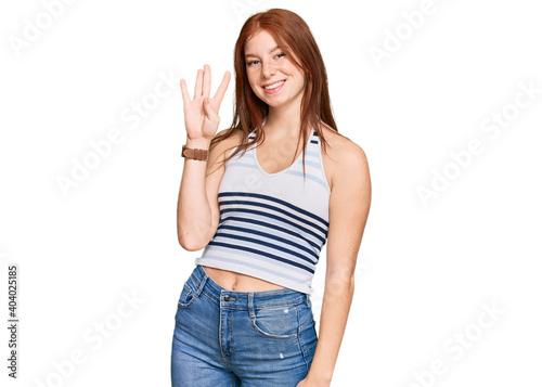 Young read head woman wearing casual clothes showing and pointing up with fingers number four while smiling confident and happy.