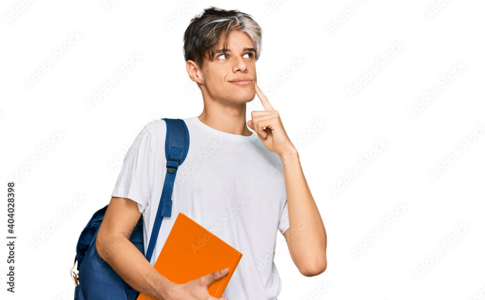 Young hispanic man wearing student backpack and holding books serious face thinking about question with hand on chin, thoughtful about confusing idea Young hispanic man wearing student backpack and holding books serious face thinking about question with hand on chin, thoughtful about confusing idea