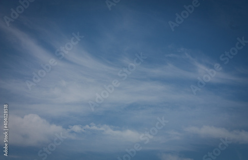 Light, semitransparent cirrus clouds in the background of the summer sky