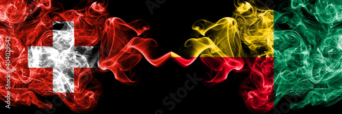 Switzerland, Swiss vs Benin, Beninese smoky mystic flags placed side by side. Thick colored silky abstract smoke flags.