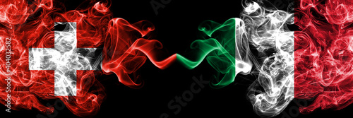 Switzerland, Swiss vs Italy, Italian smoky mystic flags placed side by side. Thick colored silky abstract smoke flags.