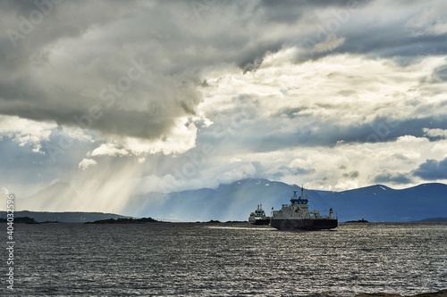 two white Norwegian car ferries approach in the rain