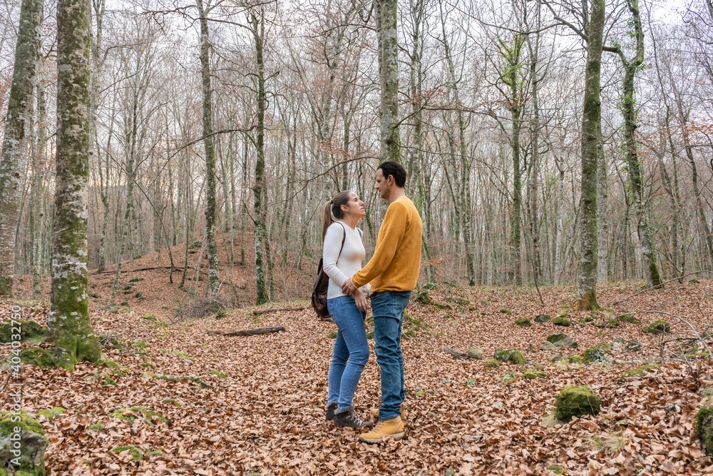 Beautiful couple talking and giving hands in forest.Love Romantic concept and friendship lifestyle .Travel with couple or friends. Beautiful couple talking and giving hands in forest.Love Romantic concept and friendship lifestyle .Travel with couple or friends.