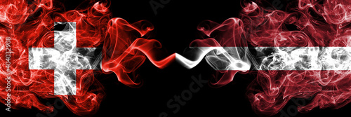Switzerland, Swiss vs Latvia, Latvvian smoky mystic flags placed side by side. Thick colored silky abstract smoke flags.