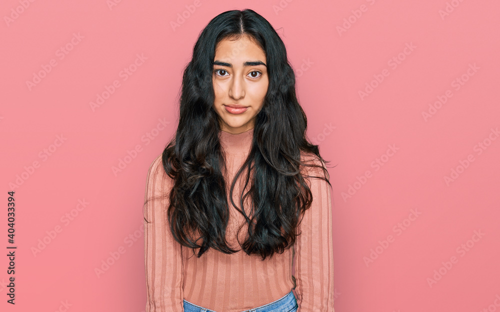 Fototapeta premium Hispanic teenager girl with dental braces wearing casual clothes depressed and worry for distress, crying angry and afraid. sad expression.