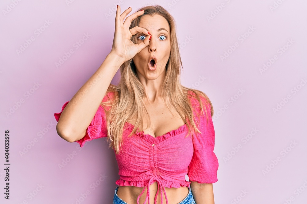 Beautiful caucasian woman wearing casual clothes doing ok gesture shocked with surprised face, eye looking through fingers. unbelieving expression. Beautiful caucasian woman wearing casual clothes doing ok gesture shocked with surprised face, eye looking through fingers. unbelieving expression.