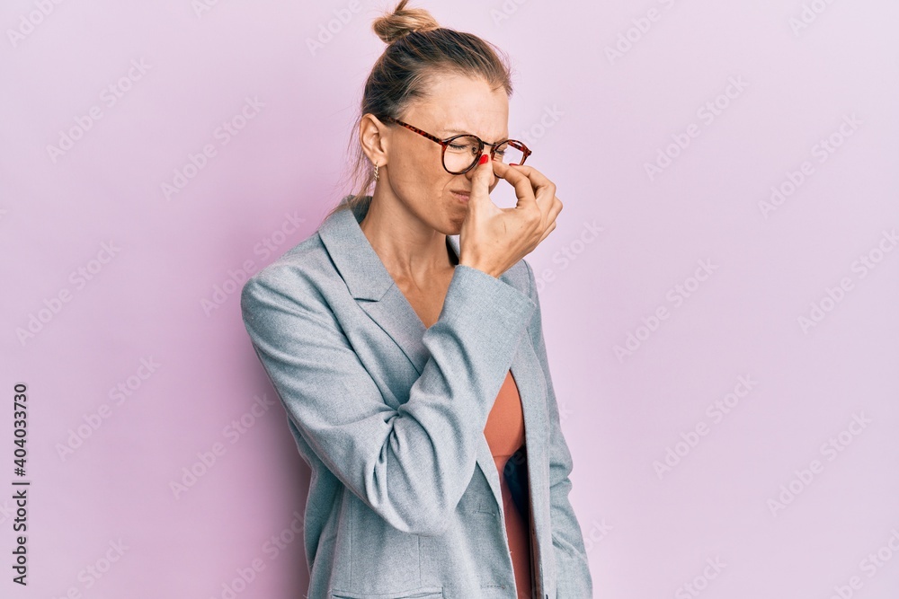 Beautiful caucasian woman wearing business jacket and glasses tired rubbing nose and eyes feeling fatigue and headache. stress and frustration concept.