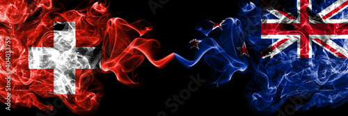 Switzerland  Swiss vs New Zealand  Kiwi smoky mystic flags placed side by side. Thick colored silky abstract smoke flags.