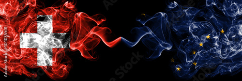Switzerland, Swiss vs United States of America, America, US, USA, American, Alaska, Alaskan smoky mystic flags placed side by side. Thick colored silky abstract smoke flags.