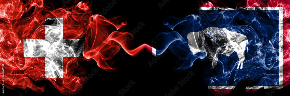 Naklejka premium Switzerland, Swiss vs United States of America, America, US, USA, American, Wyoming smoky mystic flags placed side by side. Thick colored silky abstract smoke flags.
