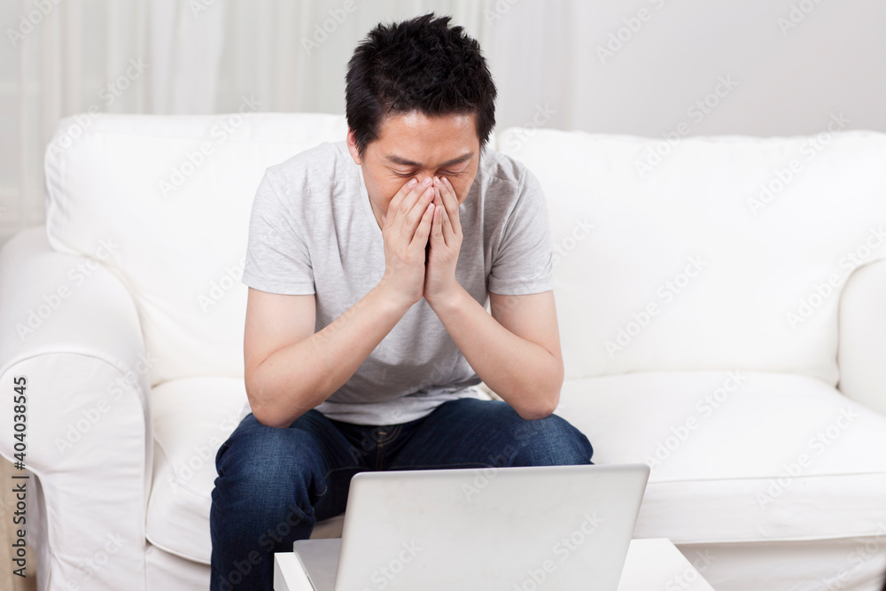 Cheerful businessman using a laptop computer in sofa Cheerful businessman using a laptop computer in sofa