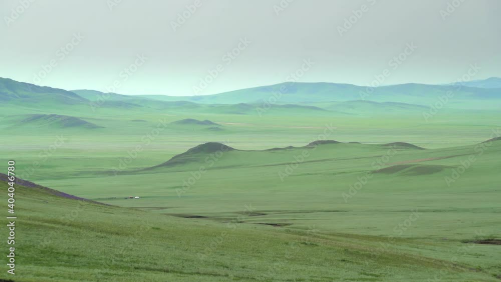 Plain in the treeless wide valley.Grassland prairie meadow wold pasture steppe plateau tableland lowland mountain mountainous terrain geography slope ridge hilly hill hills vast extensive Plain in the treeless wide valley.Grassland prairie meadow wold pasture steppe plateau tableland lowland mountain mountainous terrain geography slope ridge hilly hill hills vast extensive