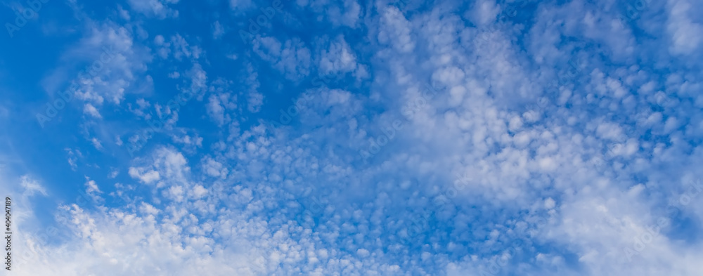 Blue clean sky with white clouds background