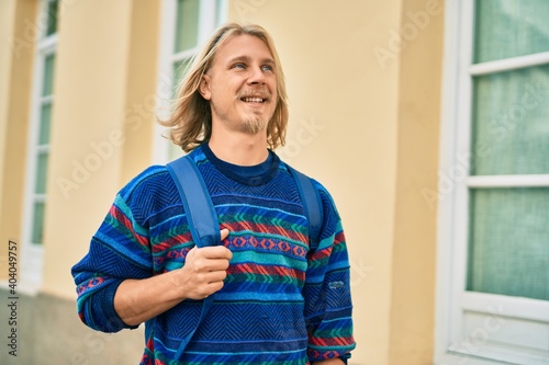 Young scandinavian student man smiling happy standing at the city.