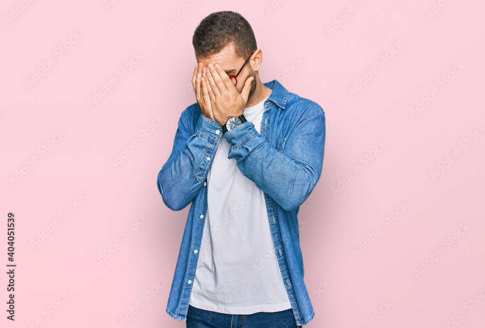 Young caucasian man wearing casual clothes with sad expression covering face with hands while crying. depression concept. Young caucasian man wearing casual clothes with sad expression covering face with hands while crying. depression concept.