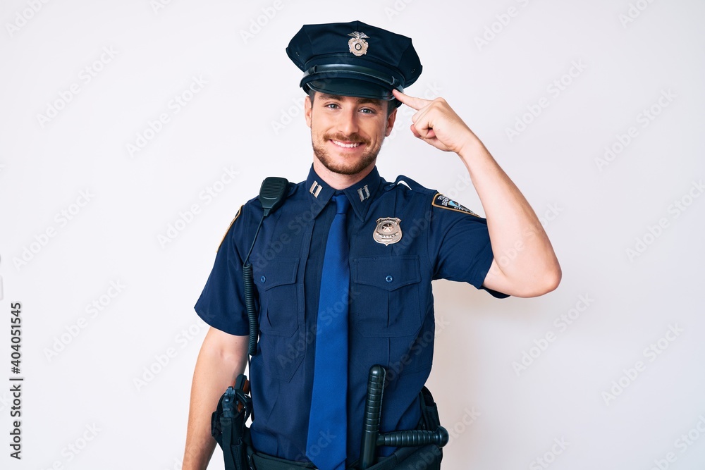 Young caucasian man wearing police uniform smiling pointing to head with one finger, great idea or thought, good memory Young caucasian man wearing police uniform smiling pointing to head with one finger, great idea or thought, good memory