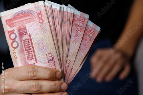 Man holds yuan. Currency of the China - One red hundred renminbi or yuan notes photo