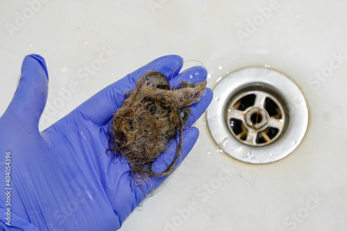 draining the sink in the bathroom with hair