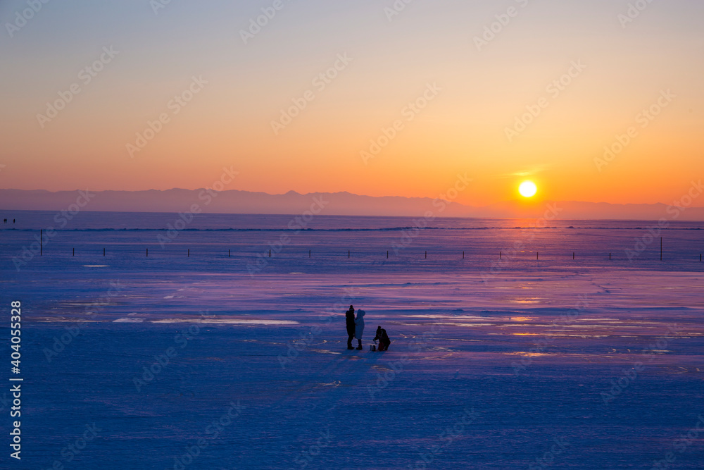 Texture of frozen water in winter lake Shards of ice as clear as glass, with traces of frozen bubbles, clear frosty Blocks of broken blue ice on sky background,Baikal lake,Siberia,Russia high season.
