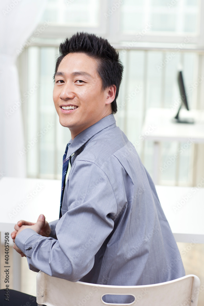 A happy young business man in office A happy young business man in office