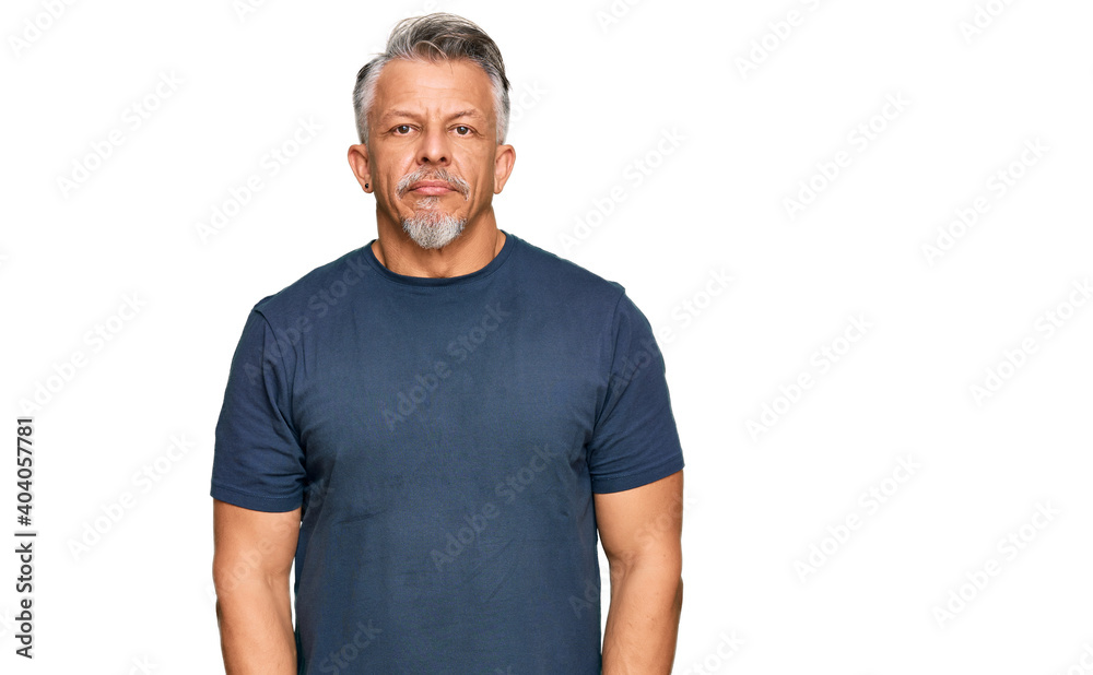 Middle age grey-haired man wearing casual clothes relaxed with serious expression on face. simple and natural looking at the camera. Middle age grey-haired man wearing casual clothes relaxed with serious expression on face. simple and natural looking at the camera.