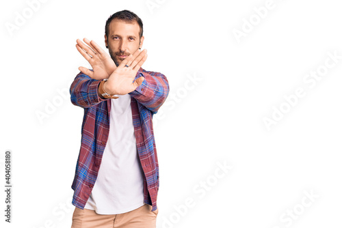 Young handsome man wearing casual clothes rejection expression crossing arms and palms doing negative sign, angry face © Krakenimages.com