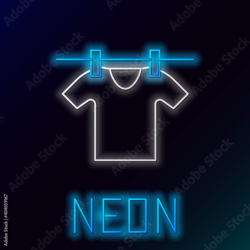 Glowing neon line Drying clothes icon isolated on black background. Clean shirt. Wash clothes on a rope with clothespins. Clothing care and tidiness. Colorful outline concept. Vector.