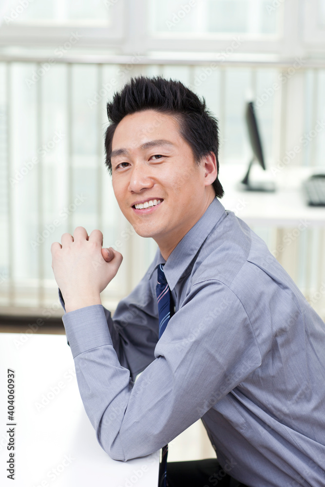 A happy young business man in office
