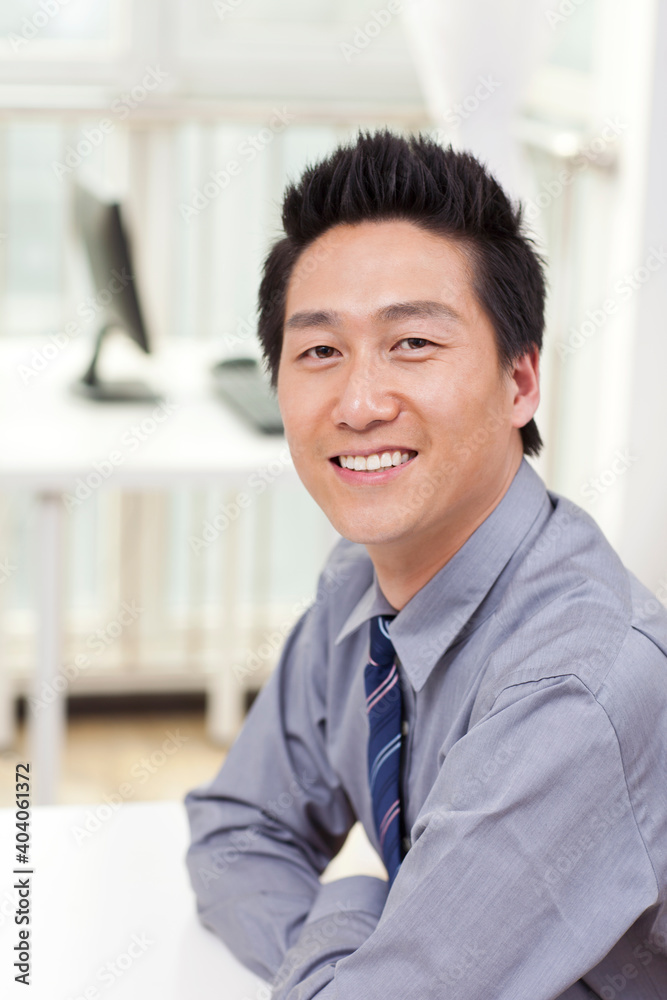 A happy young business man in office A happy young business man in office