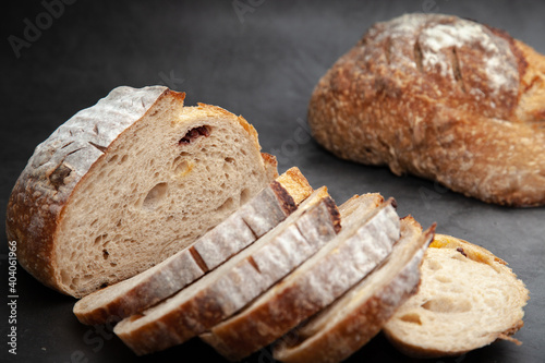 Sliced sourdough bread on dark cement background.