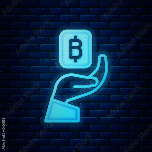 Glowing neon Hand holding Bitcoin icon isolated on brick wall background. Blockchain technology, digital money market, cryptocoin wallet. Vector.