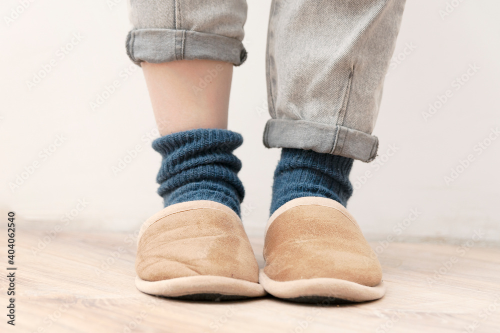 Being at home concept. Slippers on women's legs. Soft comfortable slipper for cozy home Being at home concept. Slippers on women's legs. Soft comfortable slipper for cozy home