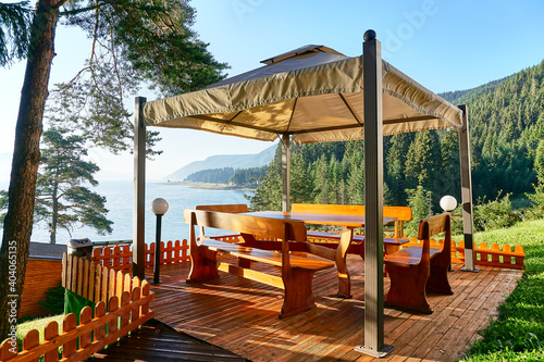 Leinwand Poster Relaxing pergola with wonderful landscape view