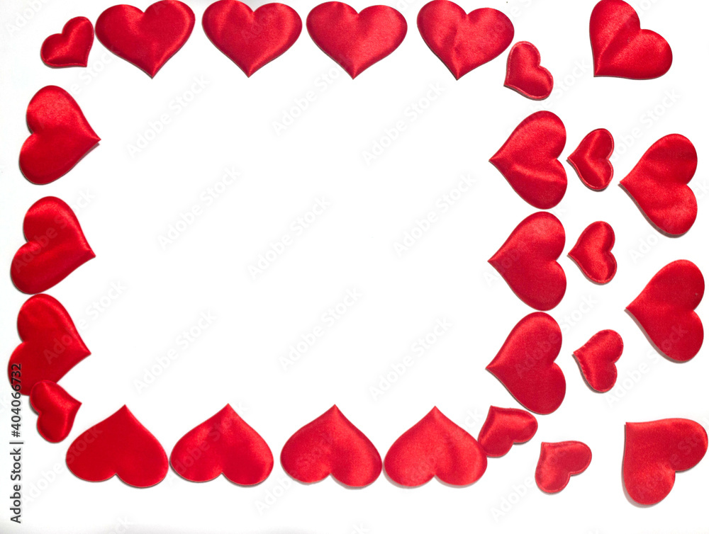 A lot of red hearts that lie on a white background. A place for congratulations.
