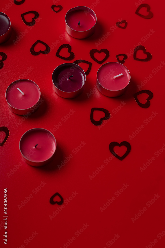 Red candles and hearts on red background