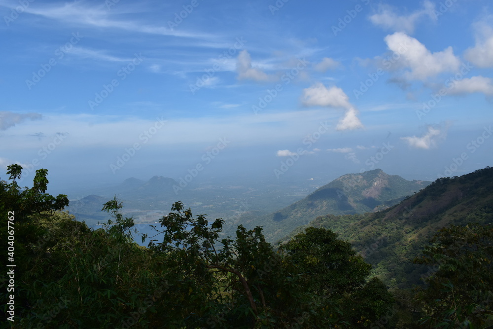 Landscape view of foggy mountain and cloudy blue sky