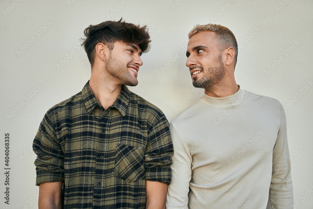 Young gay couple smiling happy standing at the city. Young gay couple smiling happy standing at the city.