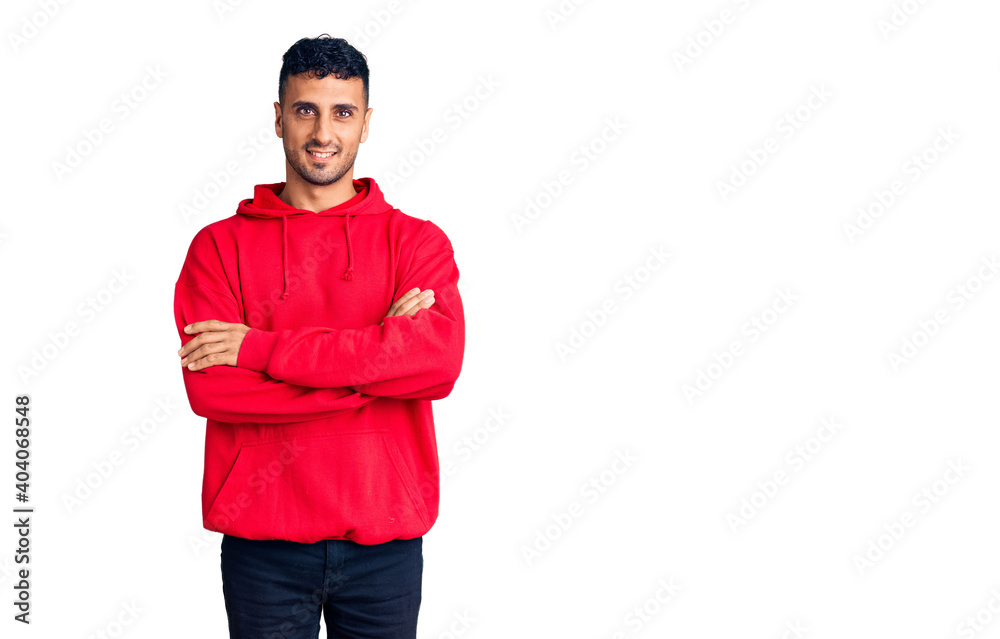 Naklejka premium Young hispanic man wearing casual clothes happy face smiling with crossed arms looking at the camera. positive person.