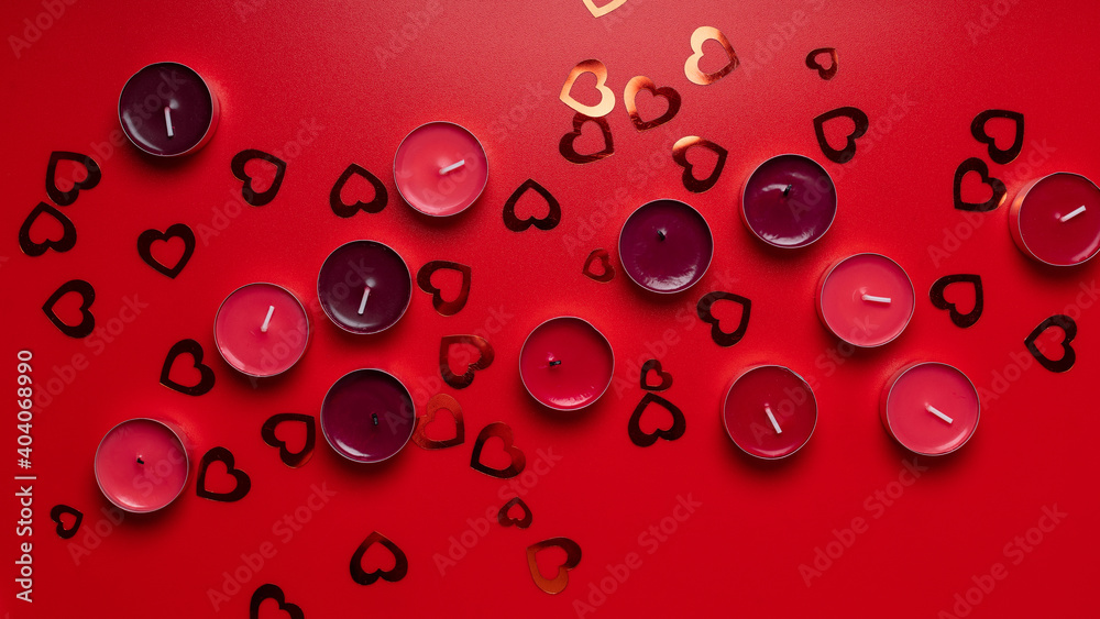 Red candles and hearts on red background