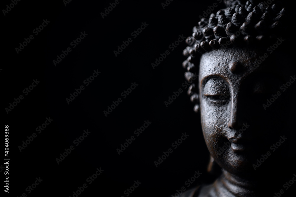  Meditating Buddha Statue isolated on black background. Copy space.